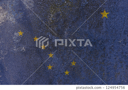 Alaska State Flag. Dirty Alaska state flag on rusty metal surface. Alaska State Flag. Dirty Alaska state flag on rusty metal surface. 124954756