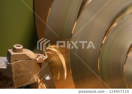 Close up scene the lathe machine finish cut the brass material. Close up scene the lathe machine finish cut the brass material. 124957114