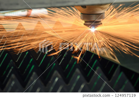 The fiber laser cutting machine cut the metal plate with the sparkling light. 124957119