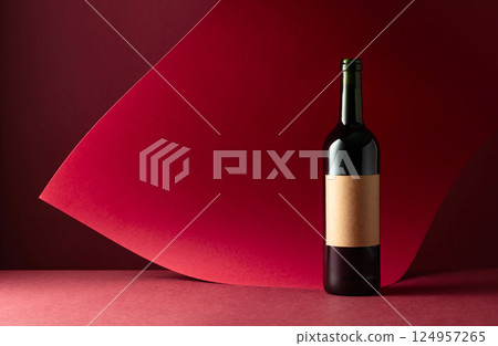 Bottle of red wine on a red background. Bottle of red wine on a red background. 124957265