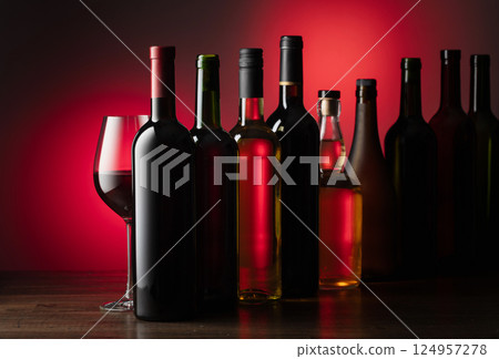 Bottles of wine on a old wooden table. Bottles of wine on a old wooden table. 124957278