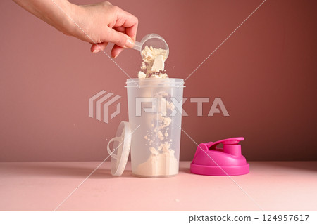 Pink, strawberry protein drink in a pink shaker, food supplement concept 124957617
