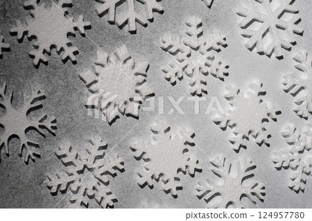 White snowflakes on a gray background. 124957780