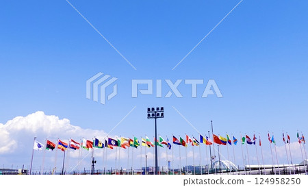 EXPO2025 Osaka Kansai Expo - A scene of international flags fluttering near the East Gate, Yumeshima, Konohana Ward, Osaka City 124958250