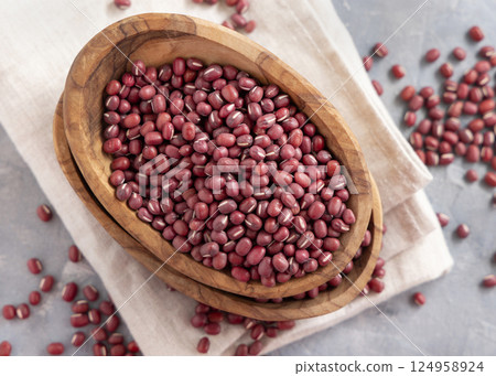 Bowls full of dried azuki beans on gray top view. Vegetarian protein source, East Asian legumes 124958924