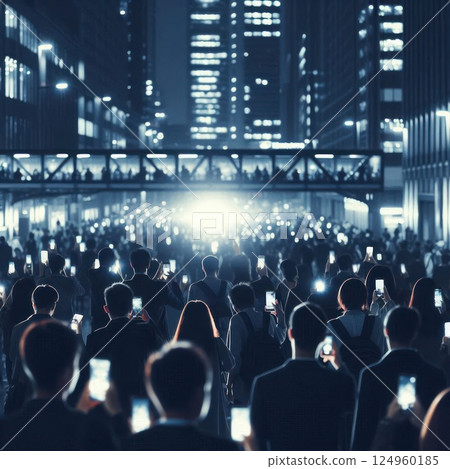 A crowd of people with phones on a dark street of the city. 124960185