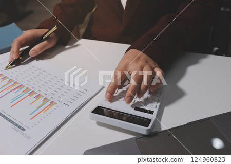Tax deduction planning concept. Women use a calculator to calculate expenses and taxes to receive tax deductions for personal individual Income. tax return for individual persons.monthly expenses 124960823