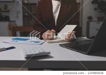 Tax deduction planning concept. Women use a calculator to calculate expenses and taxes to receive tax deductions for personal individual Income. tax return for individual persons.monthly expenses 124960836
