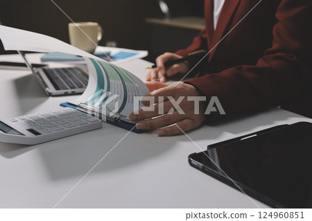 Tax deduction planning concept. Women use a calculator to calculate expenses and taxes to receive tax deductions for personal individual Income. tax return for individual persons.monthly expenses Tax deduction planning concept. Women use a calculator to calculate expenses and taxes to receive tax deductions for personal individual Income. tax return for individual persons.monthly expenses 124960851