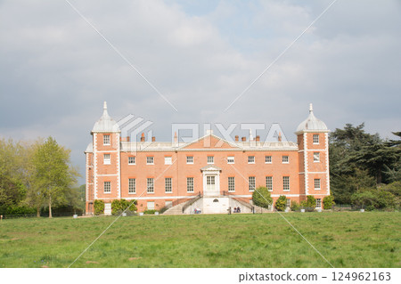 A historic red brick building built in a spacious park under a blue sky in Osterley Park, a suburb of London A historic red brick building built in a spacious park under a blue sky in Osterley Park, a suburb of London 124962163