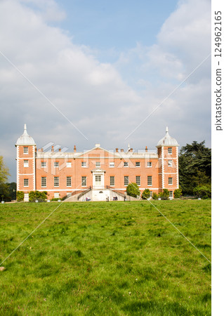 A historic red brick building built in a spacious park under a blue sky in Osterley Park, a suburb of London A historic red brick building built in a spacious park under a blue sky in Osterley Park, a suburb of London 124962165