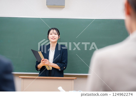 A young female teacher teaching at a school 124962274