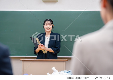 A young female teacher teaching at a school 124962275