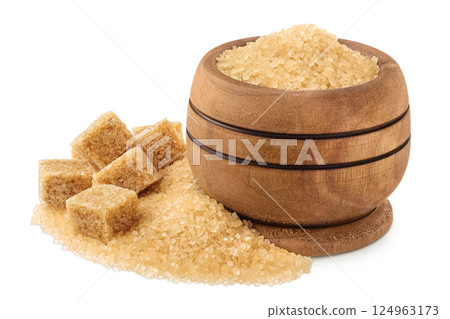 Pile of brown granulated sugar and sugar cubes in wooden bowl isolated on white background. Pile of brown granulated sugar and sugar cubes in wooden bowl isolated on white background. 124963173