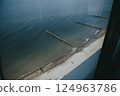 Aerial view from a window showing beach and ocean scenery 124963786