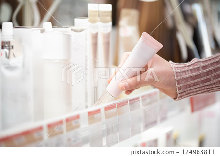 Shopper's hands choosing cosmetics Shopper's hands choosing cosmetics 124963811