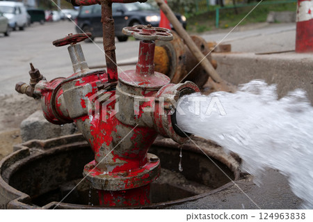 Water flows from faucet and pipe. Draining water from building plumbing system Water flows from faucet and pipe. Draining water from building plumbing system 124963838