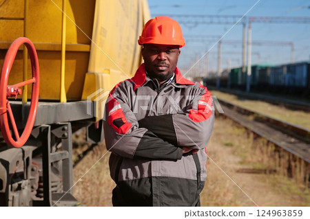 Railroad man in uniform and red hard hat look at the camera 124963859