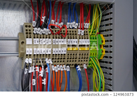 Terminal blocks in electrical cabinet. Cable connector. Industrial electricals 124963873
