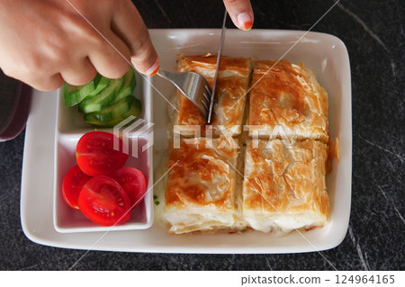 Traditional Turkish Cuisine Pastries borek on a plate Traditional Turkish Cuisine Pastries borek on a plate 124964165