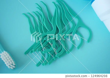 Dental Floss Picks Placed Aesthetically on a Blue Background for an Appealing Visual 124964208