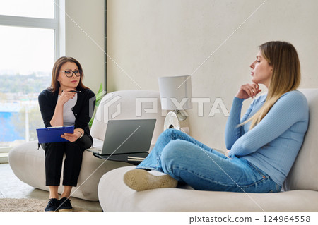 Young woman in mental therapy talking with professional psychologist, psychotherapist 124964558