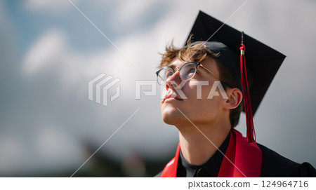 Young male graduate looking up hopeful towards future sky clouds 124964716