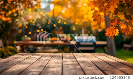Autumn party in backyard garden with grill and wooden table 124965346