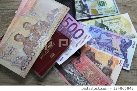 Banknotes of different countries and colors on the table Banknotes of different countries and colors on the table 124965942