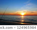 Fishing from the sandy beach, spinning rods and fishing rods stand on the shore 124965984