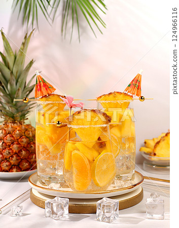 Various cocktails with pieces of mango, pineapple and ice in glasses with rims and umbrellas. Concept of tropical party and relaxation. Advertising business card for bar and restaurant menu 124966116
