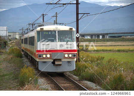 A former Seibu express train running through the countryside A former Seibu express train running through the countryside 124966961