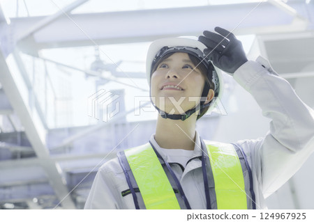 一名年輕女工在建築物屋頂上進行檢查工作。照片由東京電子專門學校、電波學園株式會社提供。 124967925