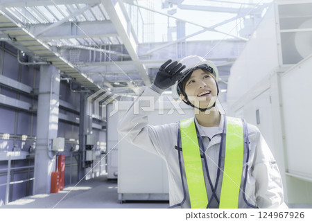 A young female worker carrying out inspection work on the roof of a building. Photo courtesy of Tokyo Electronics College, Denpa Gakuen Corporation. A young female worker carrying out inspection work on the roof of a building. Photo courtesy of Tokyo Electronics College, Denpa Gakuen Corporation. 124967926