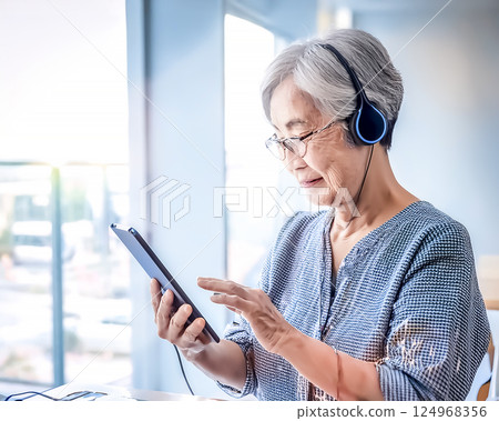 Technology and the elderly: Images of senior citizens using digital devices 124968356