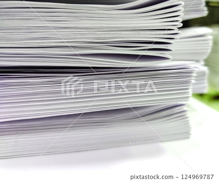 Close-up, a stack of glued book blocks prepared for binding in a printing house 124969787