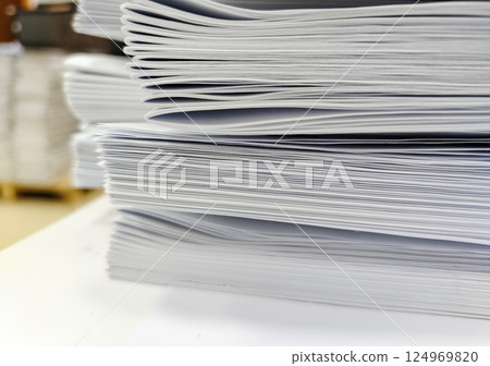 Close-up, a stack of glued book blocks prepared for binding in a printing house Close-up, a stack of glued book blocks prepared for binding in a printing house 124969820