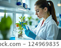 Biotechnology, nature and the female scientist in the lab, research with a plant in a test tube to test gmo's 124969835