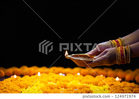 Clay diya lamps lit during diwali celebration, Diwali, or Dipawali, is India's biggest and most important holiday. 124971974