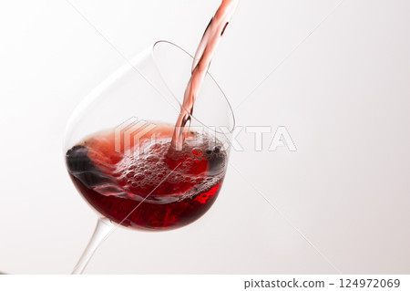 Pour the red wine into the glass Pour the red wine into the glass 124972069