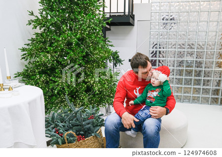 Dad and daughter fooling around near the Christmas tree 124974608