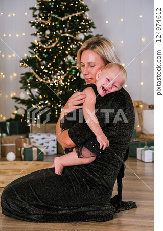 mom and little baby in christmas interior mom and little baby in christmas interior 124974612