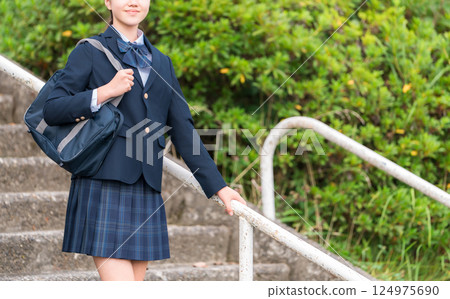 Junior high school, high school, and elementary school students in uniform descending the stairs of a school building Junior high school, high school, and elementary school students in uniform descending the stairs of a school building 124975690