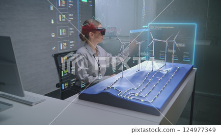 Advanced Office: Female Professional Uses Augmented Reality 3D Hologram to Visualize Wind Farm 124977349