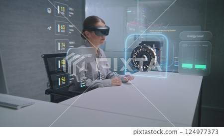 Female Engineer Uses Augmented Reality Headset to Visualize 3D Holographic Model of Wind Turbine Female Engineer Uses Augmented Reality Headset to Visualize 3D Holographic Model of Wind Turbine 124977373