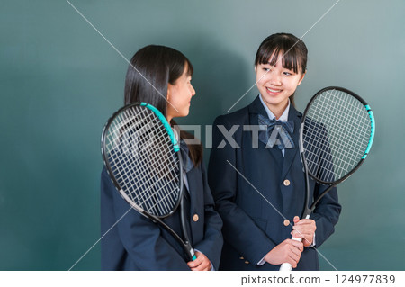 Junior high school girls having a conversation in a school classroom 124977839