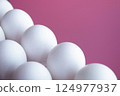 White Eggs arranged Diagonal Line against Vibrant Pink background. Minimalist composition highlights contrast and simplicity, emphasizes Clean Lines Diet Proteins Breakfast articles Easter themes 124977937