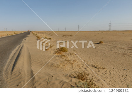 Road through the desert from Sher Khan Bandar to Kunduz in Kunduz Province, Afghanistan Road through the desert from Sher Khan Bandar to Kunduz in Kunduz Province, Afghanistan 124980381