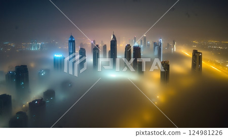 Skyscrapers Emerging Through Dense Fog at Night with City Lights 124981226