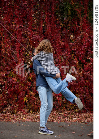 Young Cute Female Hugs Boyfriend. In Autumn Outdoor. Lovers Walking in Park. Attractive Funny Couple. Lovestory in Forest. Man and Woman. Cute Lovers in the Park. Family Concept. Happy Couple. 124981708